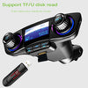 A black Bluetooth car stereo FM transmitter device with a plug attached, shown against a light gray background.