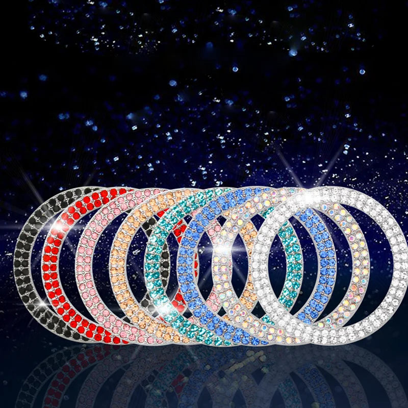 A display of multiple concentric rings of decorative diamond rhinestones forming a car start button cover.