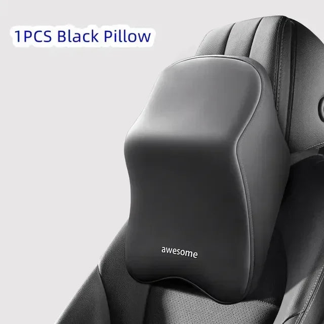 A single black pillow designed as an ergonomic car headrest cushion for neck and shoulder support.