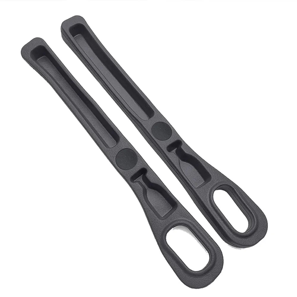 Black car seat gap filler organizer with elongated slots and a loop for storage