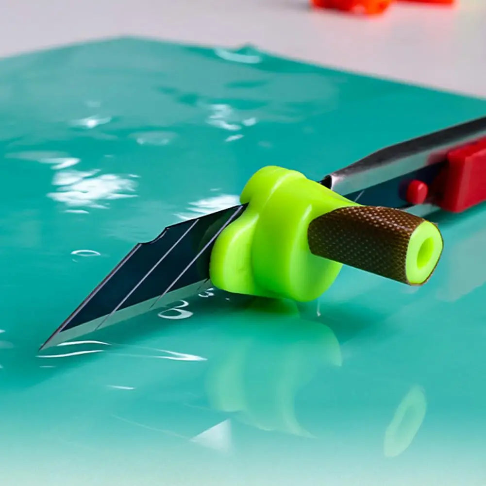 A bright green precision film cutting guide is shown slicing through a teal surface.