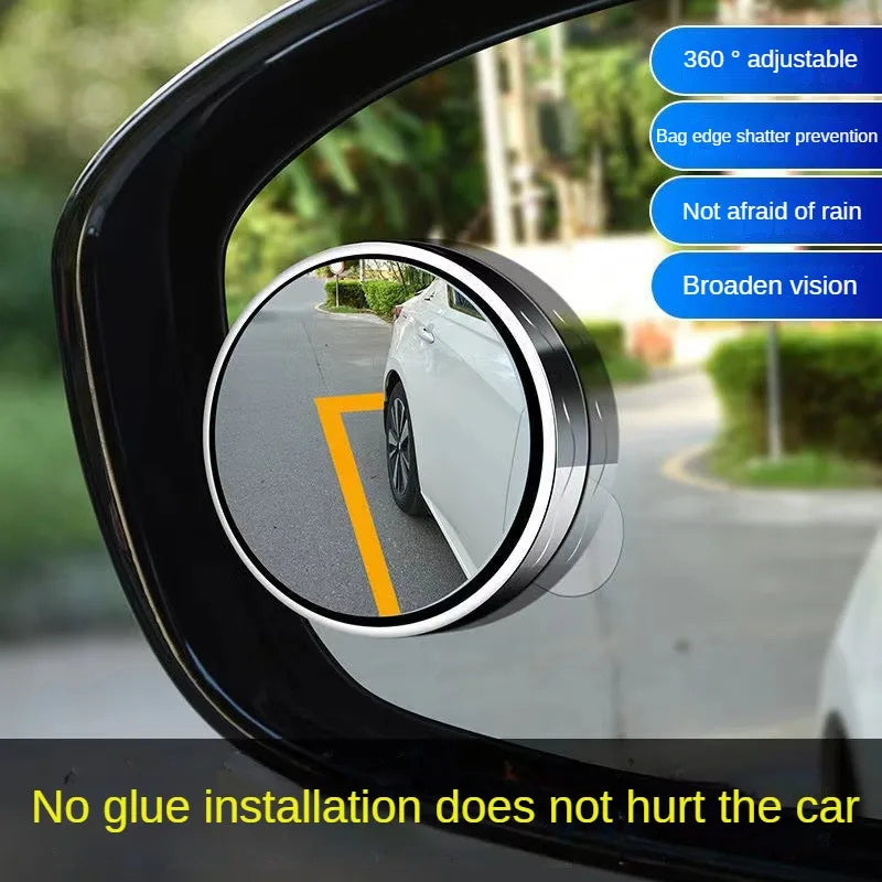 A close-up view of a 360 degree adjustable suction cup rearview mirror installed on a car window.