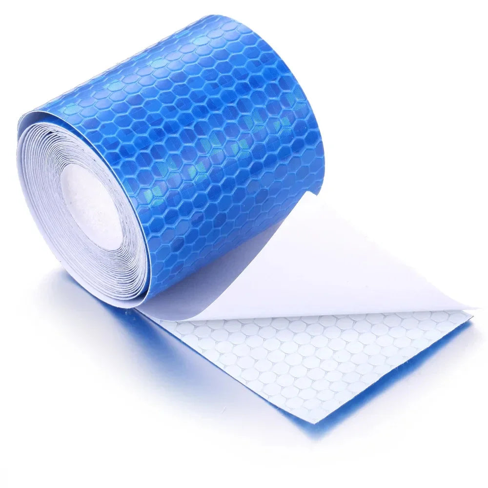 Roll of bright blue high-visibility reflective tape for vehicles, partially unrolled.