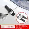 Modified body kit clips made of large carbon fiber visible on a white car hood.