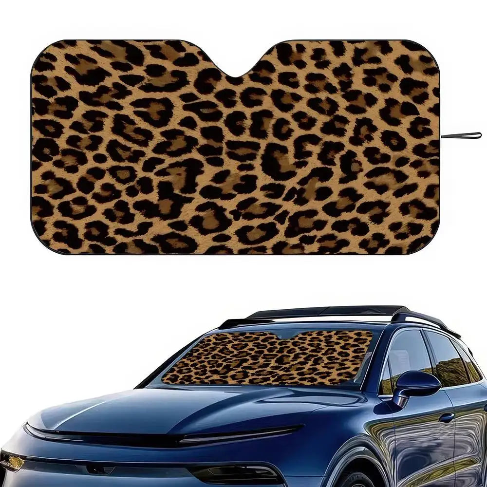 A leopard print car sunshade covering the interior of a blue car.