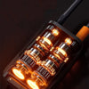 Close-up of a black portable tire inflator with multiple illuminated orange-toned inflation nozzles.