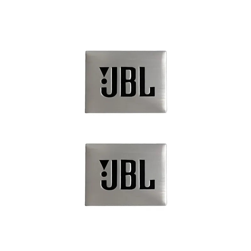 Two square silver aluminum emblems with the letters JBL engraved on them