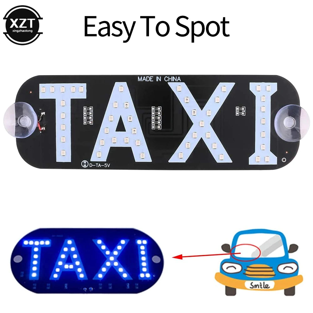 A black LED light panel with the word TAXI illuminated in white lights, used as a car taxi indicator.