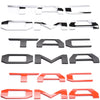 A set of 3D letter covers and emblems for a Toyota Tacoma tailgate in various colors including silver, black, and red.