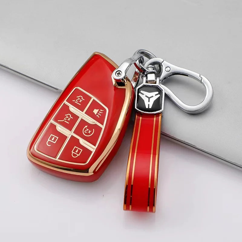 A red multi-function car key cover with a silver keychain attached, shown on a gray surface.