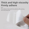 A close-up view of a thick, high-vis adhesive coating firmly adhering to a white surface.