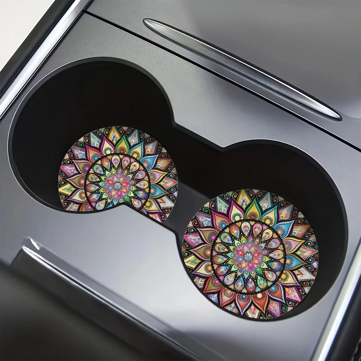 A close-up view of a silicone coaster set featuring colorful mandalas inside a modern gray container.