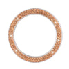 A circular cover for a car start button decorated with small rose gold diamond rhinestones.