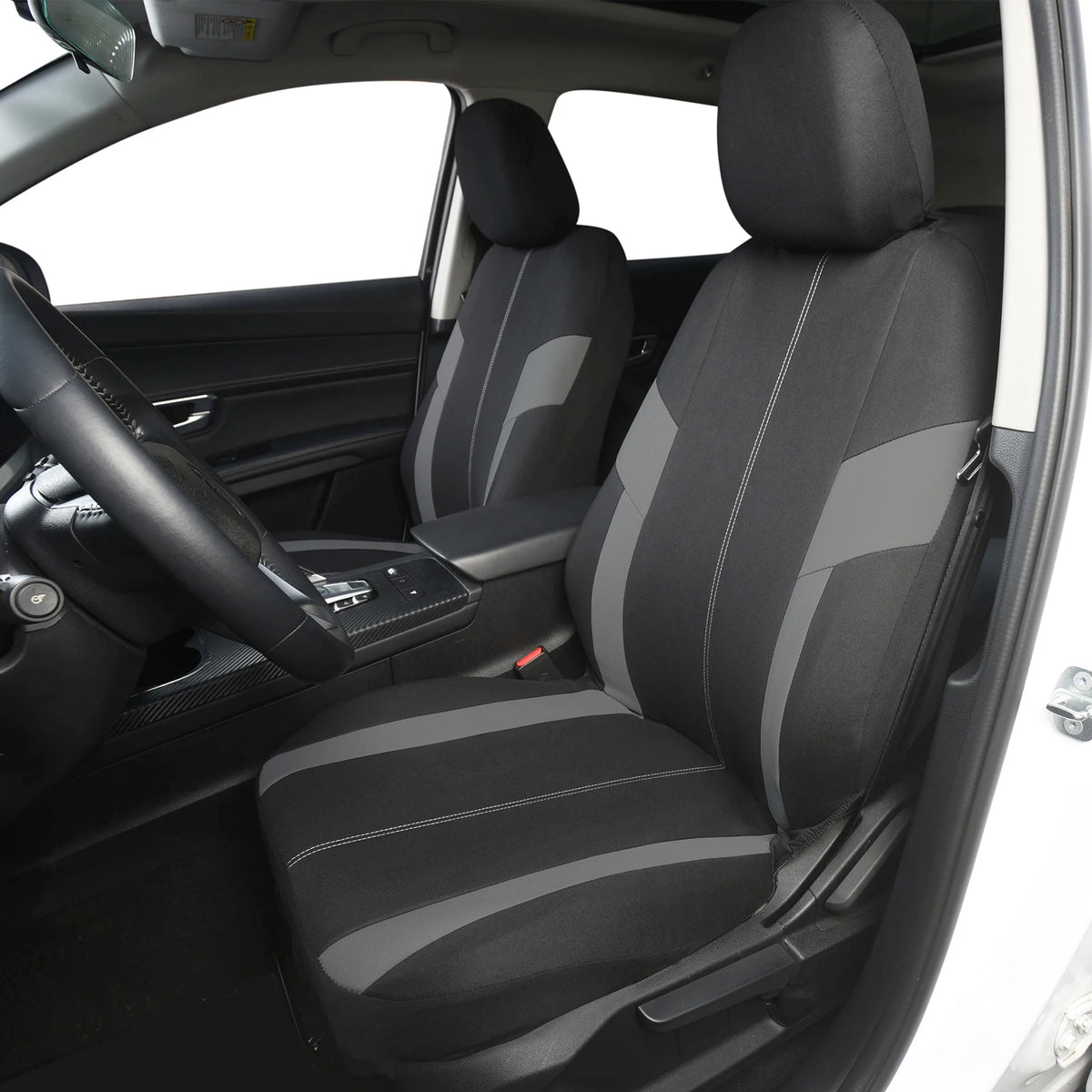 Siège de voiture noir avec housses rayées gris et noir installé dans l'habitacle.