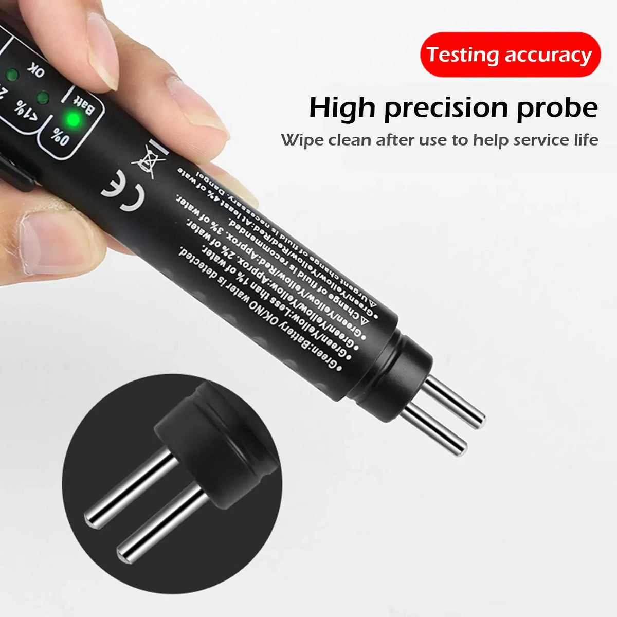 A hand holds a high precision probe for testing brake fluid accuracy, showing the tip and connector.