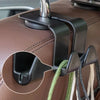 A close-up of black headrest hooks attached to a brown leather car seat, showing the mechanism for securing a child's head.