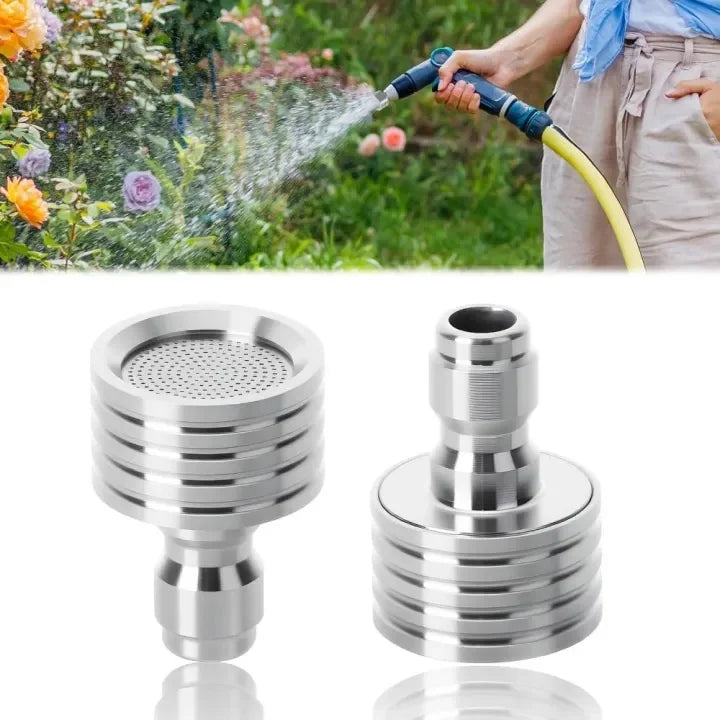 A hand is using a high-pressure stainless steel shower head nozzle to spray water onto plants.
