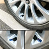 Close-up view of durable aluminum valve caps installed on a silver alloy wheel and tire.