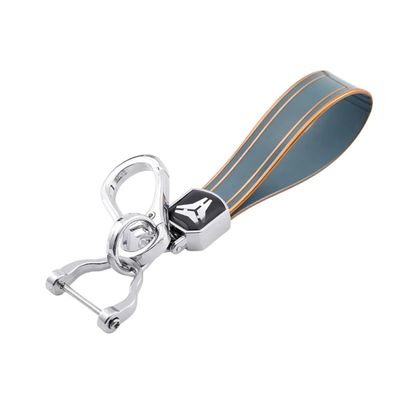 Silver TPU car key case cover with a dark blue and orange striped sleeve.