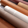 A close-up view of several premium breathable car seat cushions in various leather and fabric colors.