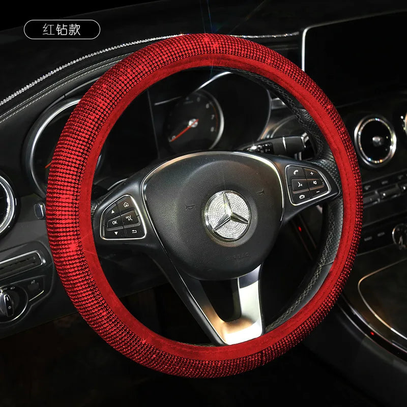 A red rhinestone bling steering wheel cover installed on a car's steering wheel.
