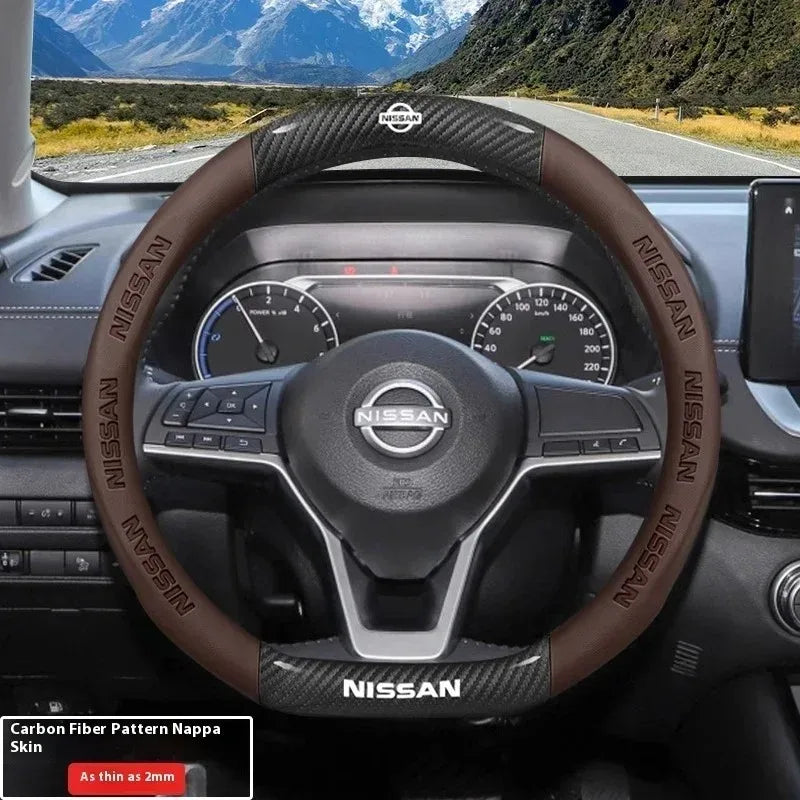Close-up of a Nissan steering wheel with a brown carbon fiber patterned Nappa leather cover.