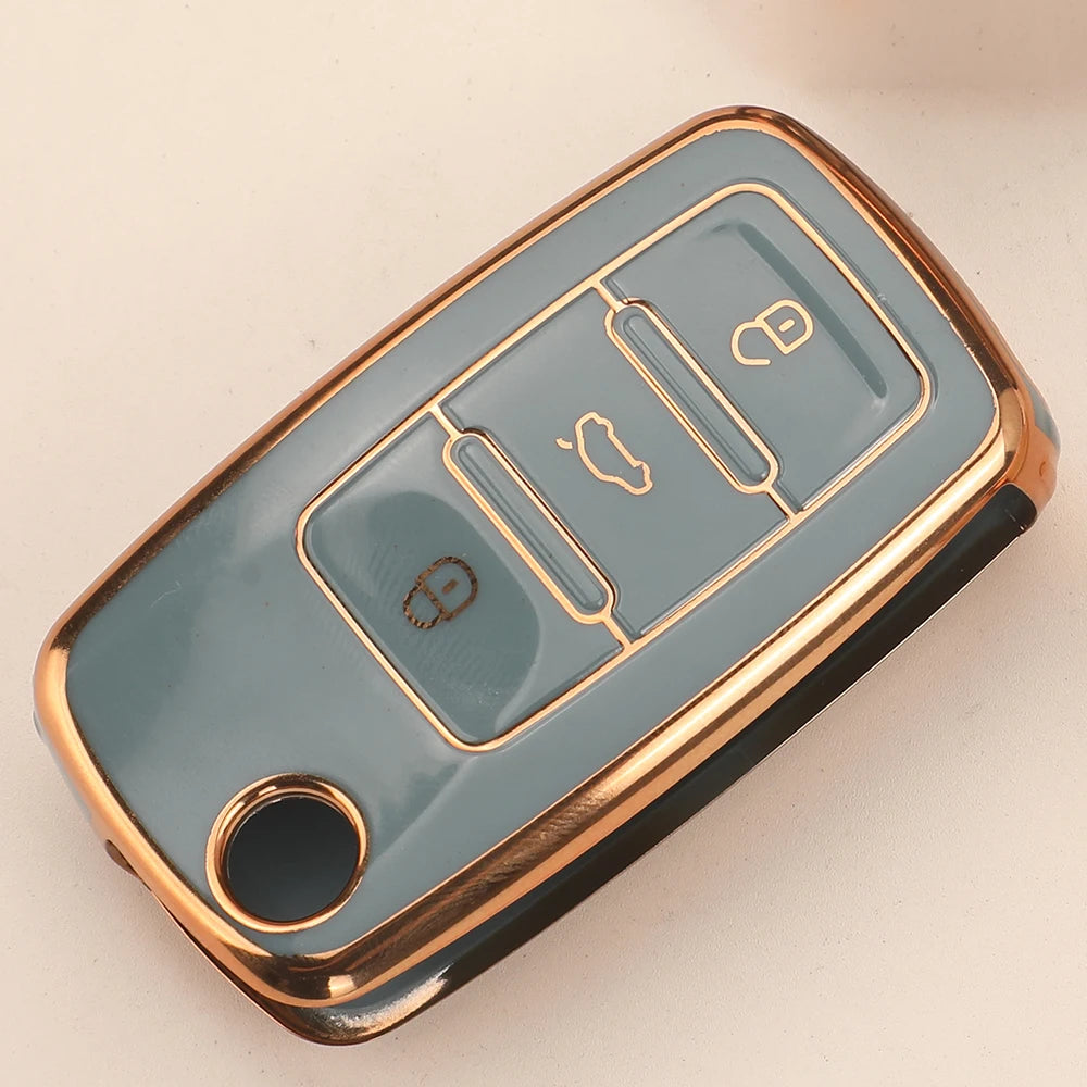 A light blue silicone TPU car key cover protector with gold accents and multiple slots.
