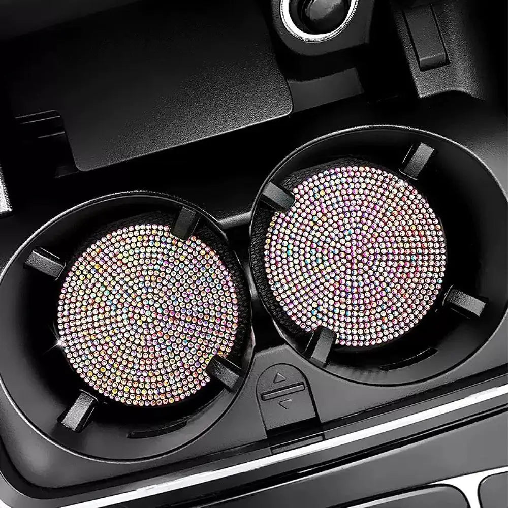 A close-up view of two imitation diamond car cup coasters in a black holder.
