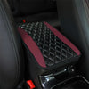 A black quilted armrest protector pad with a maroon accent is shown inside a car interior.