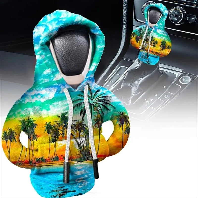 A cozy knit gear shift cover featuring a tropical scene with palm trees and bright colors.