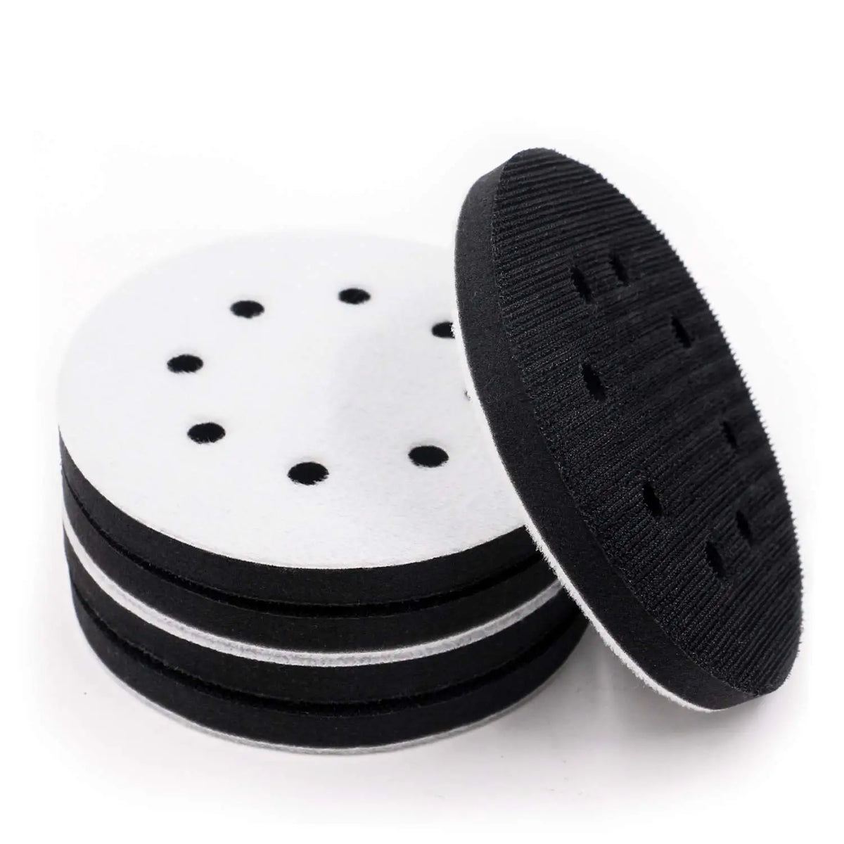 Stack of black abrasive interface pads for sanding and polishing