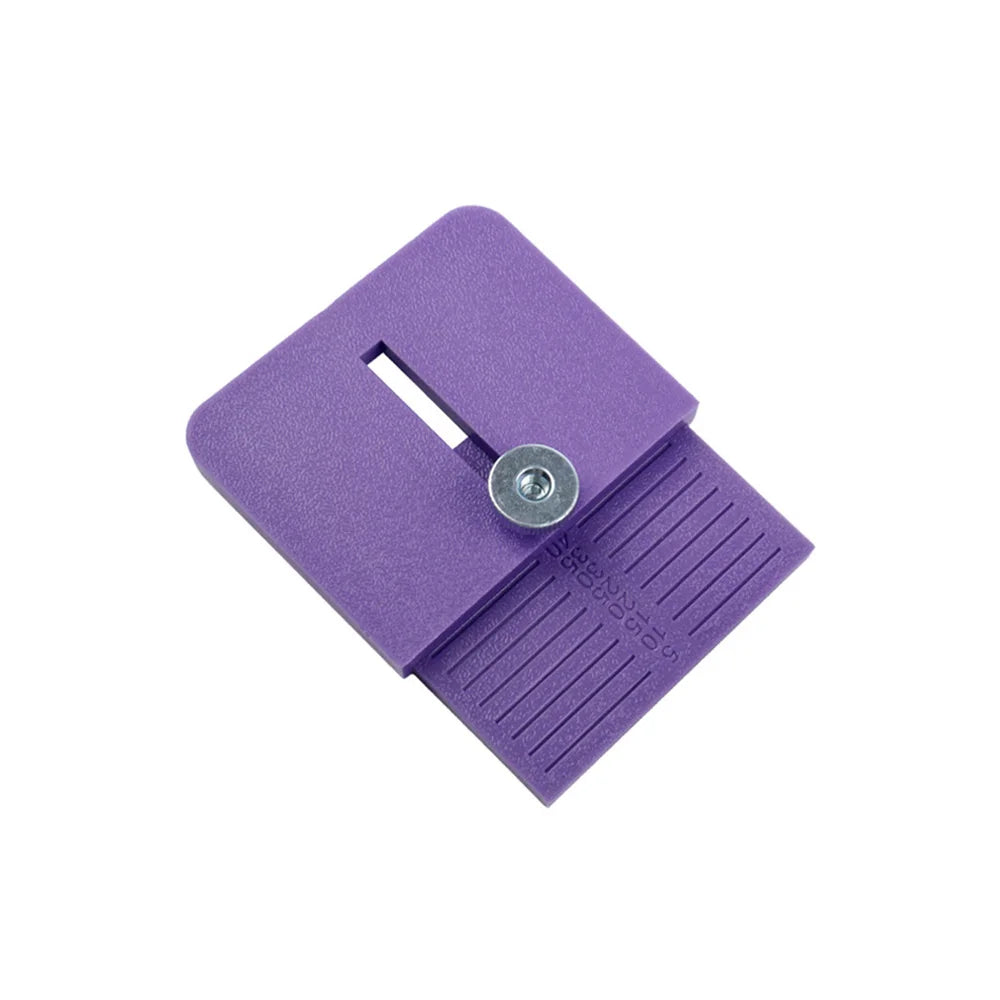 A purple precision vinyl film edge cutting applicator with a slot and a textured surface.