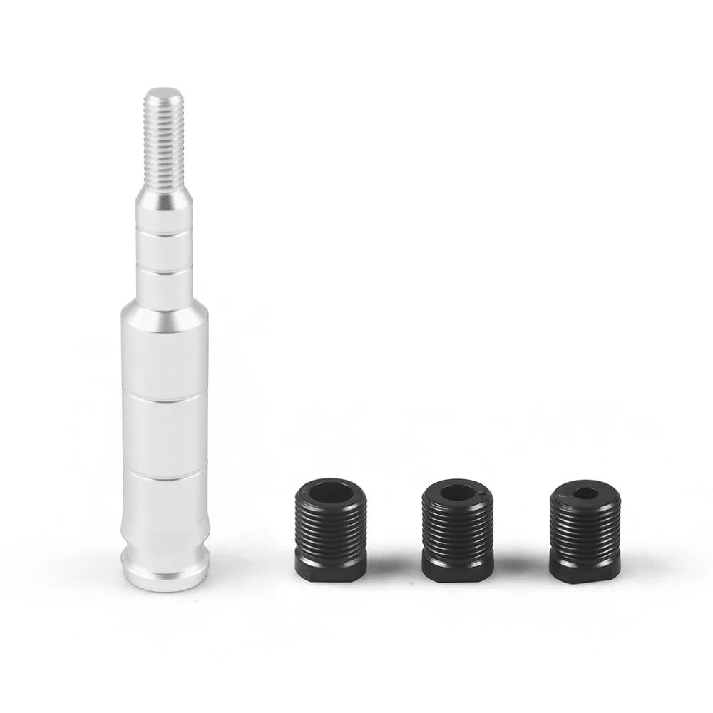 A set of aluminum gear knob extensions, including a threaded cylindrical piece and several black cylindrical knobs.