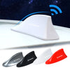 A collection of car antenna shark fin decorations in silver, black, white, and red.