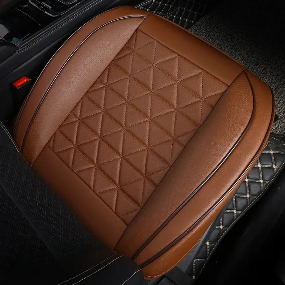 Brown quilted car front seat covers placed on a black car interior seat.