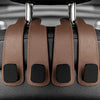 Car headrest hooks in brown leather with black accents for bag organization