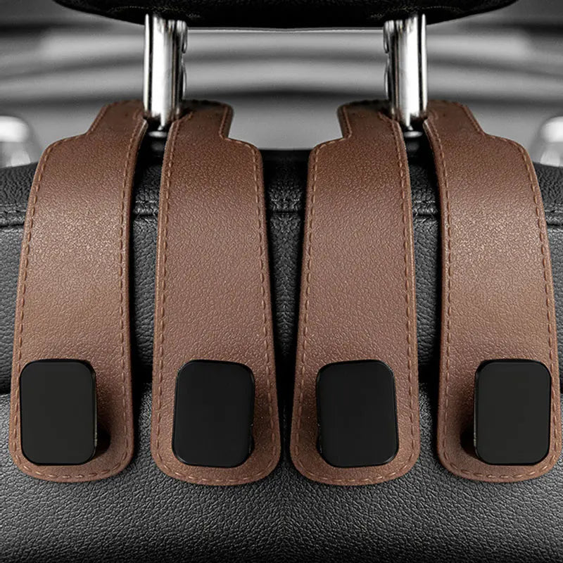 Car headrest hooks in brown leather with black accents for bag organization