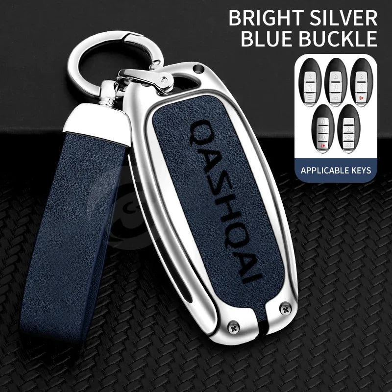 A bright silver blue buckle key cover with a dark blue strap and metal keyring, shown against a black background.