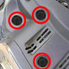 Close-up view of an automotive plastic bumper with several mounting holes and clips.