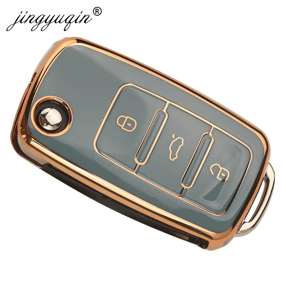 A silicone TPU car key cover protector with a gold-colored frame and multiple buttons.