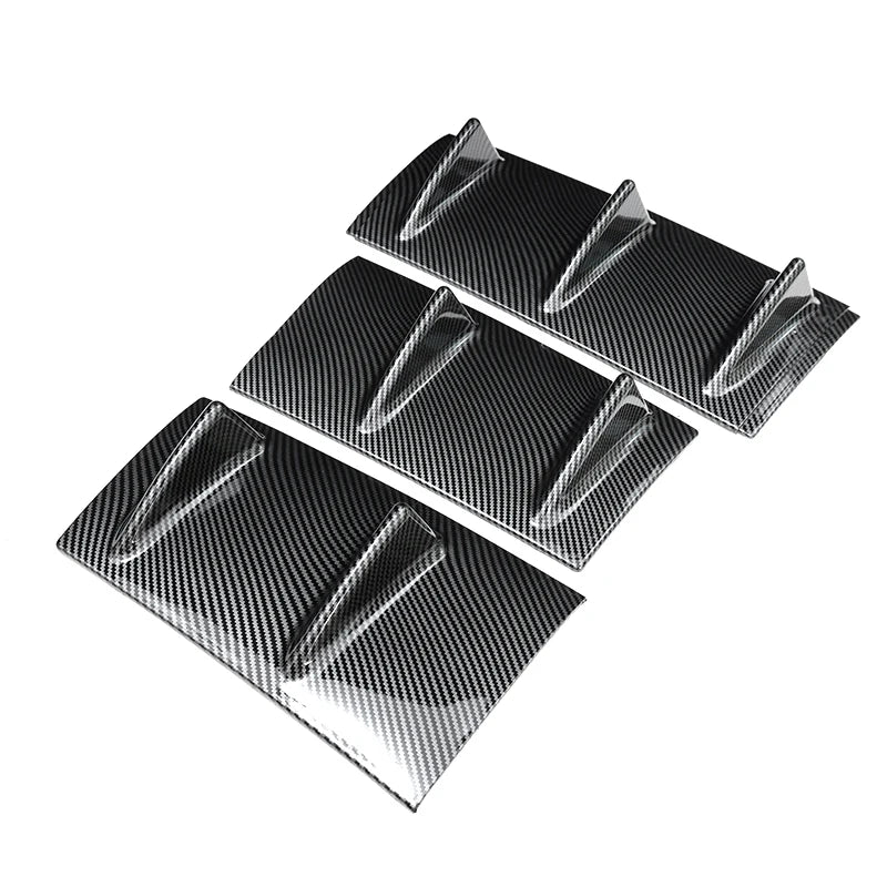 Three glossy black rear bumper lip diffusers shown from an angle.