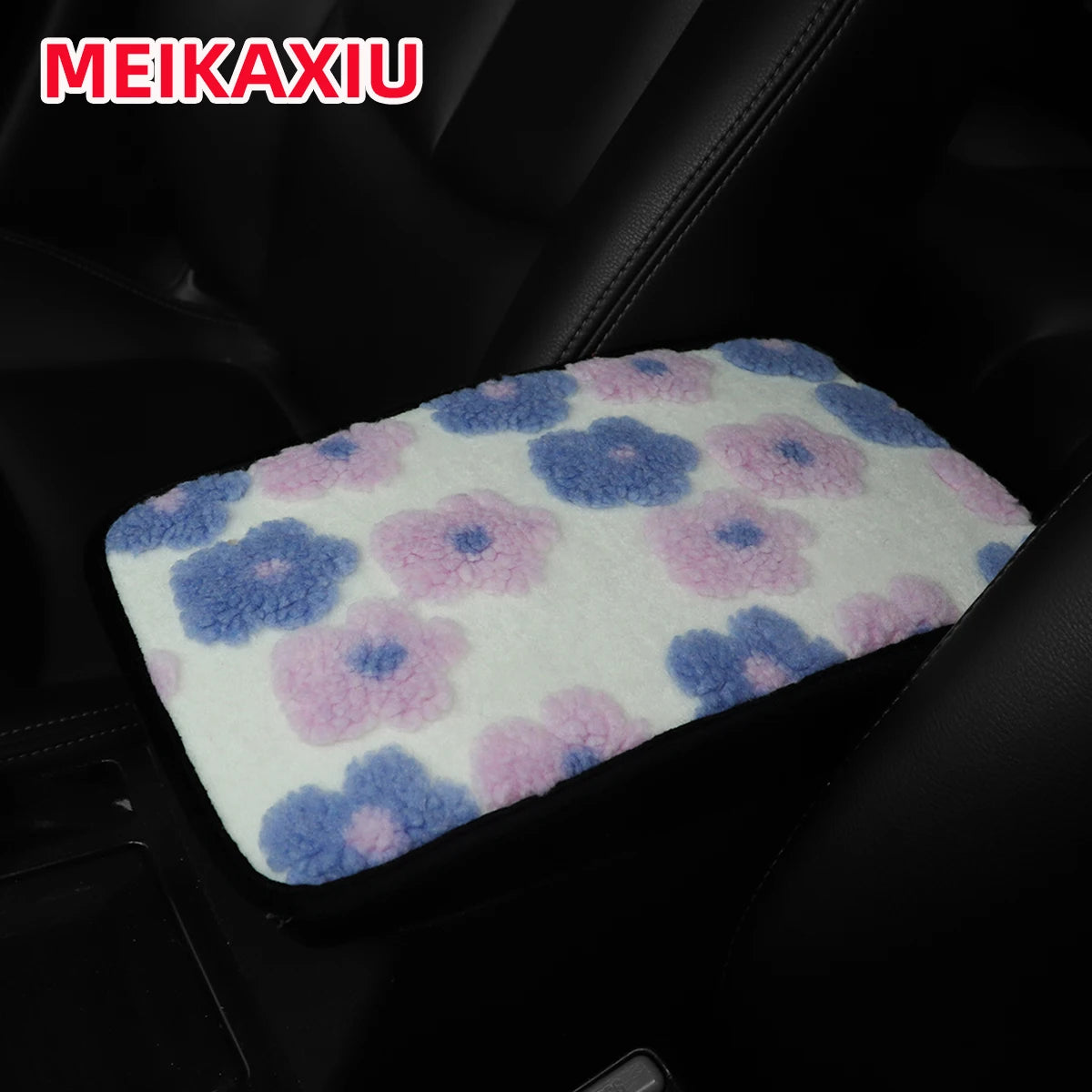 A pink and blue floral plush cushion designed for a car armrest.