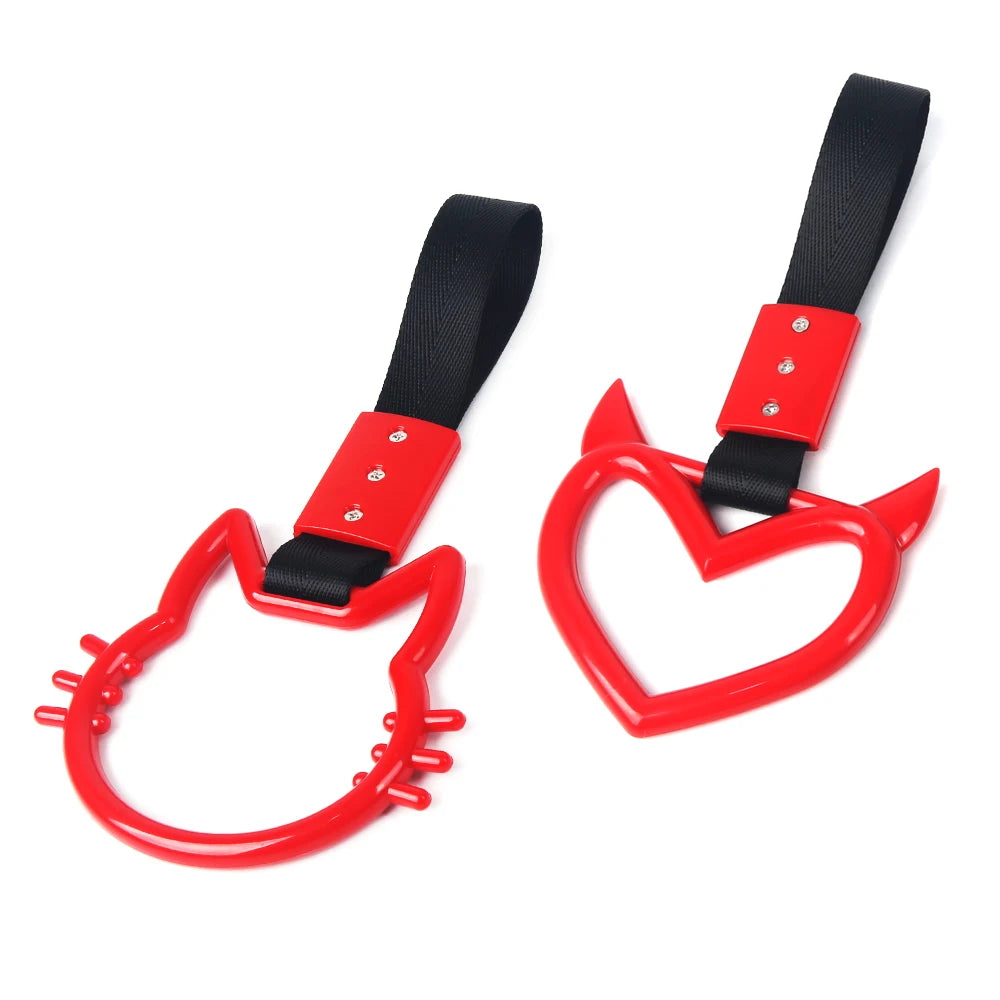 A red and black car rear bumper warning strap with a hand pull ring.