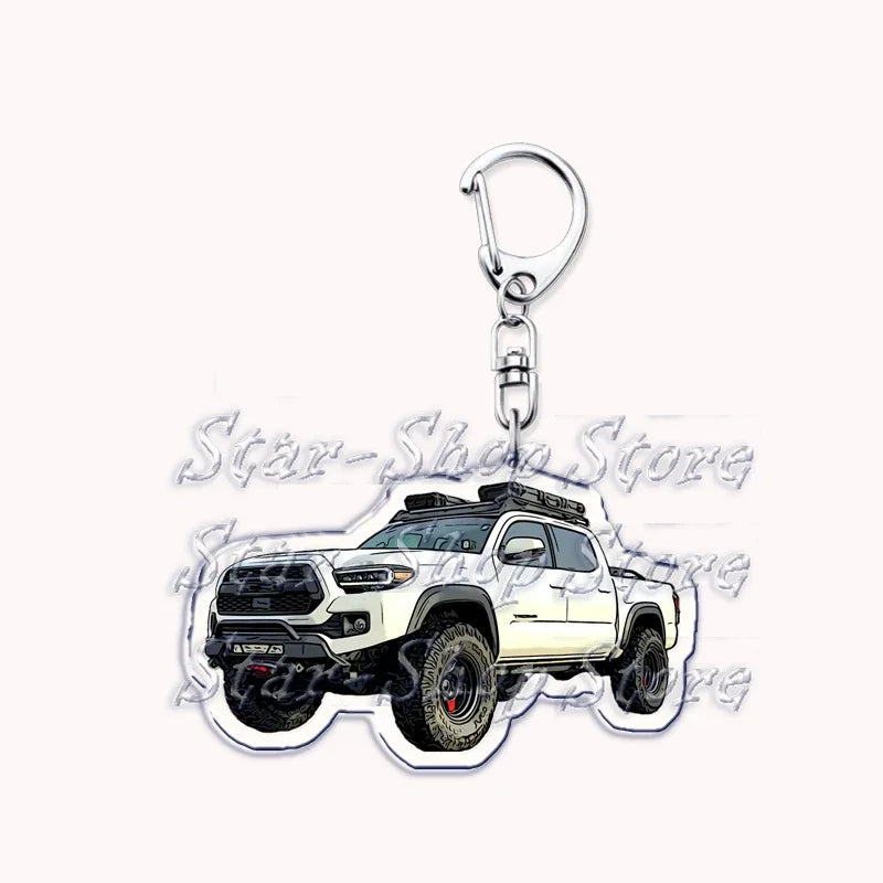 Silver acrylic keychain featuring a white off-road truck.