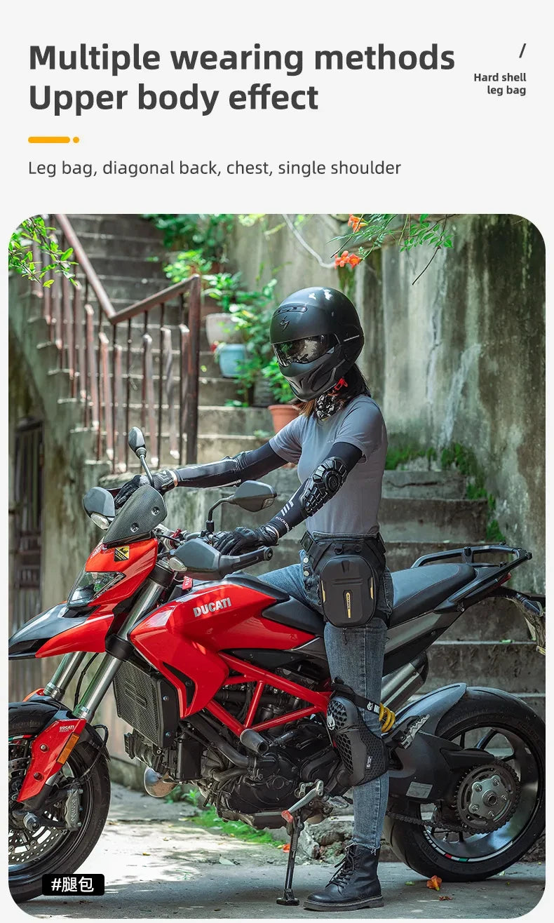 A person wearing a motorcycle helmet and leather gloves sits on a red Ducati motorcycle with a fanny pack attached to the sea