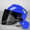 A blue lightweight rainproof half helmet is shown in a studio setting, with another similar helmet lying nearby.