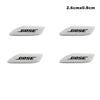 Four white 3D aluminum car audio emblems with the brand name BOSE