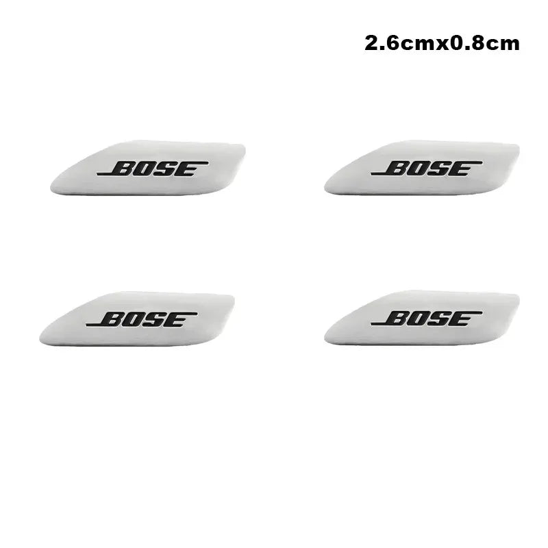 Four white 3D aluminum car audio emblems with the brand name BOSE