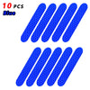 Ten blue reflective safety stickers or tape pieces arranged in a diagonal pattern.