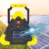 A yellow and black solar emergency warning light with a solar panel is shown on a grassy surface.